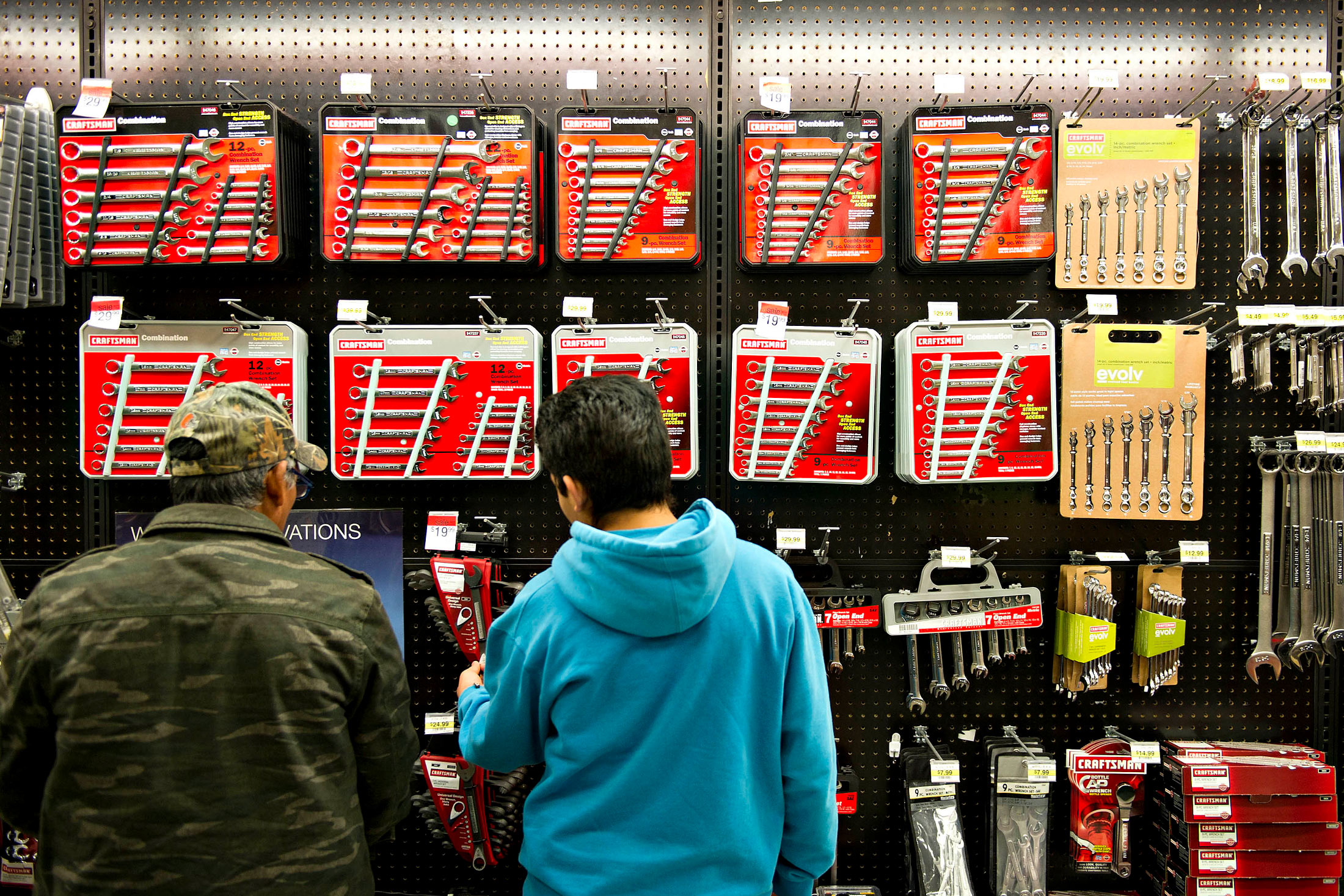 Shoppers look over Craftsman tools in a Sears store.
