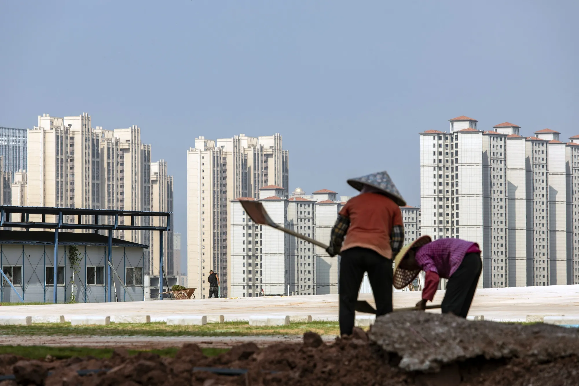 Workers in front of residential buildings under construction in Heyuan, Guangdong province, China.