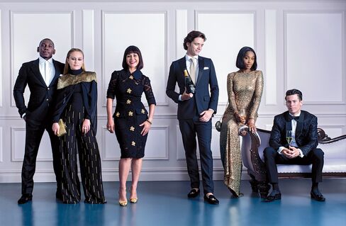 On Dwayne Thomas, food runner: wool jacquard suit, $2,850, and shirt, price upon request, both by Versace; velvet loafers by Giuseppe Zanotti Design, $825. On Mindi Taylor, day manager and server: cape, $750, and pants, $450, both by Sass and Bide; turtleneck by Boss, $225; Tempo ring by David Yurman, $5,400; brass earrings by Jennifer Fisher, $300; Fiocco Box With Love clutch by Christian Louboutin, $3,295. On Camille Becerra, co-founder: knit dress with brooches by Dolce & Gabbana, price upon request; gold metallic slingback sandals by Giuseppe Zanotti Design, $650; gold bracelet by Eddie Borgo, $300; brass bow ring by Jennifer Fisher, $280. On Wandrille Pierre Boisset, day manager and bartender: black wool tuxedo jacket, $3,600, pants, $930, shirt, $700, silk pocket square, $110, all by Dior Homme; knit tie by the Tie Bar, $25; velvet slippers by Stubbs & Wootton, $495. On Felah Voltaire, hostess: Gown by Badgley Mischka, $615; Sweet Charity bag by Christian Louboutin, $1,595; brass single-ribbon ring, $310, and earrings, $310, both by Jennifer Fisher. On Justin Herrera, chef: woven jacquard jacket, $4,995, tuxedo shirt, $595, and bow tie, $155, all by Ralph Lauren; gray socks by Nice Laundry, $49 for a pack of six; shoes by Dior Homme, $770.