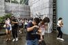 Pedestrians react after tear gas was deployed during a protest on Queensway in the Admiralty district of Hong Kong, China, on Sunday, Oct. 6, 2019.