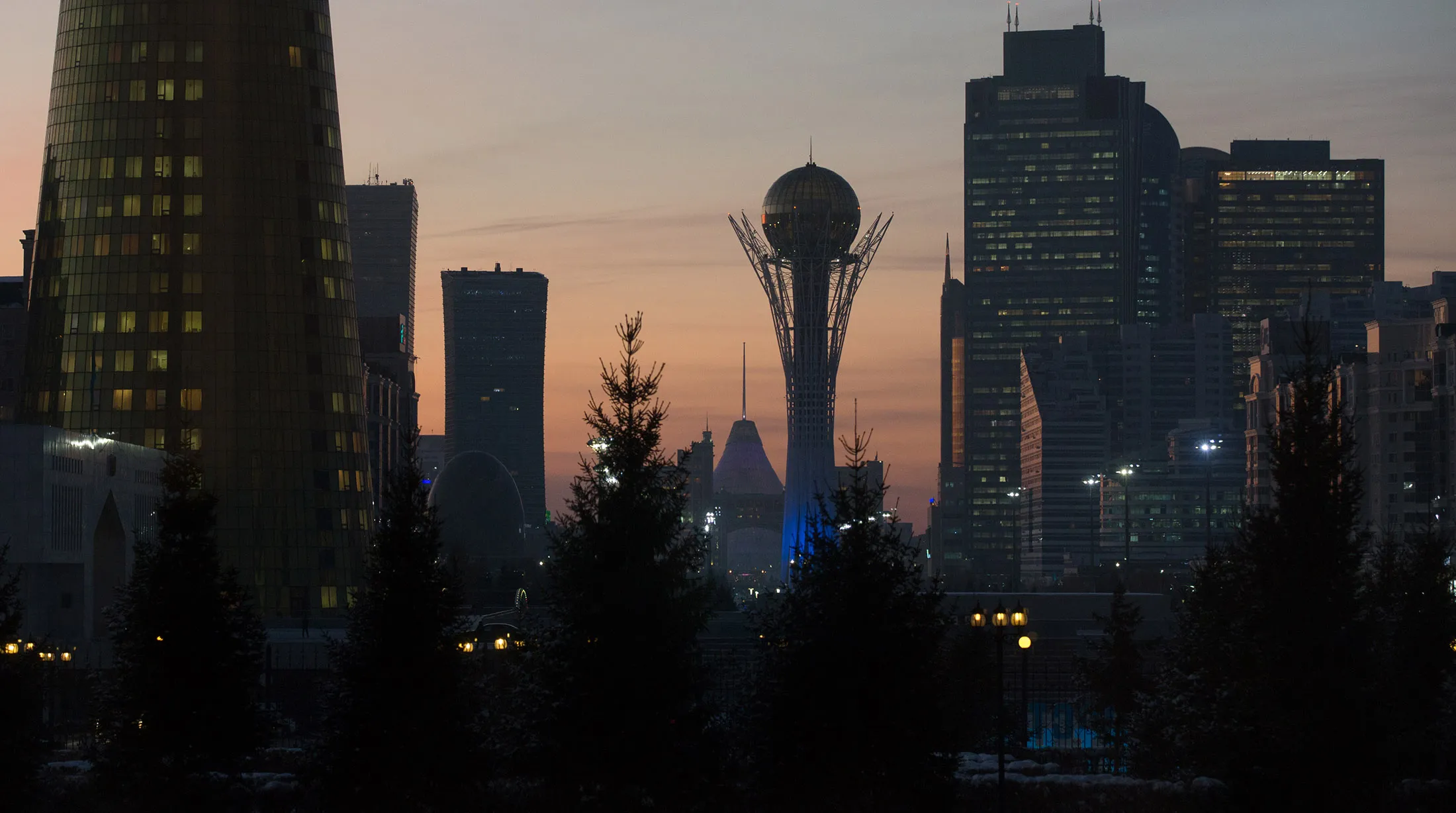 The Bayterek tower monument, center, stands flanked by skyscrapers in Astana, Kazakhstan.
