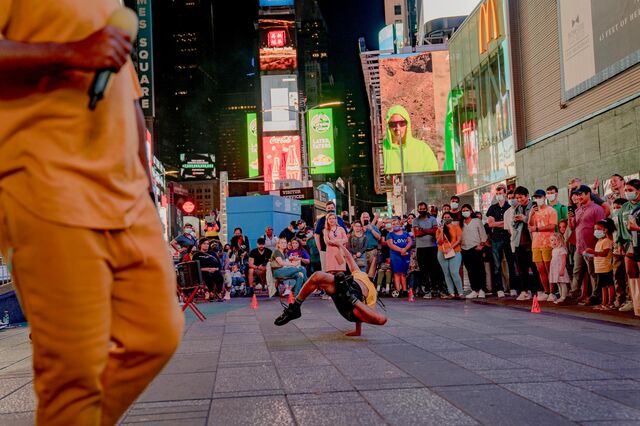 Street performers doing a stunt show at Times Square at night September 4, 2021