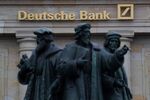 The Gutenberg memorial statue stands outside a Deutsche Bank&nbsp;bank branch in Frankfurt, Germany.