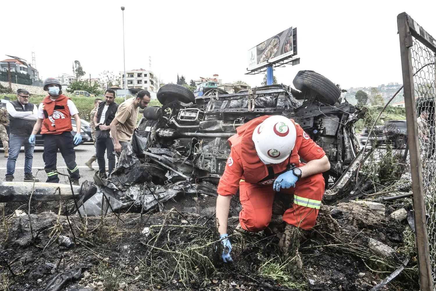 First responders inspect the site of an airstrike that targeted a vehicle in Jiyeh, Lebanon&nbsp;on April 15.