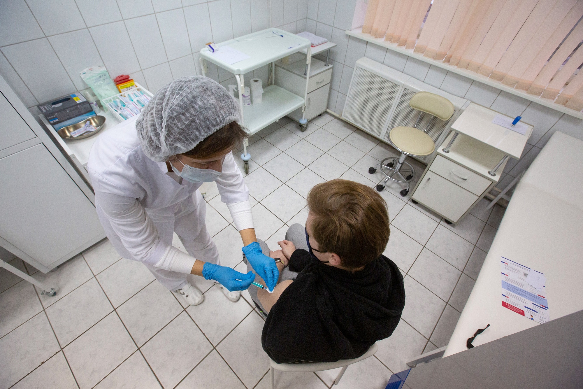 A health worker administers a Sputnik V Covid-19 vaccine shot during trials in Moscow.