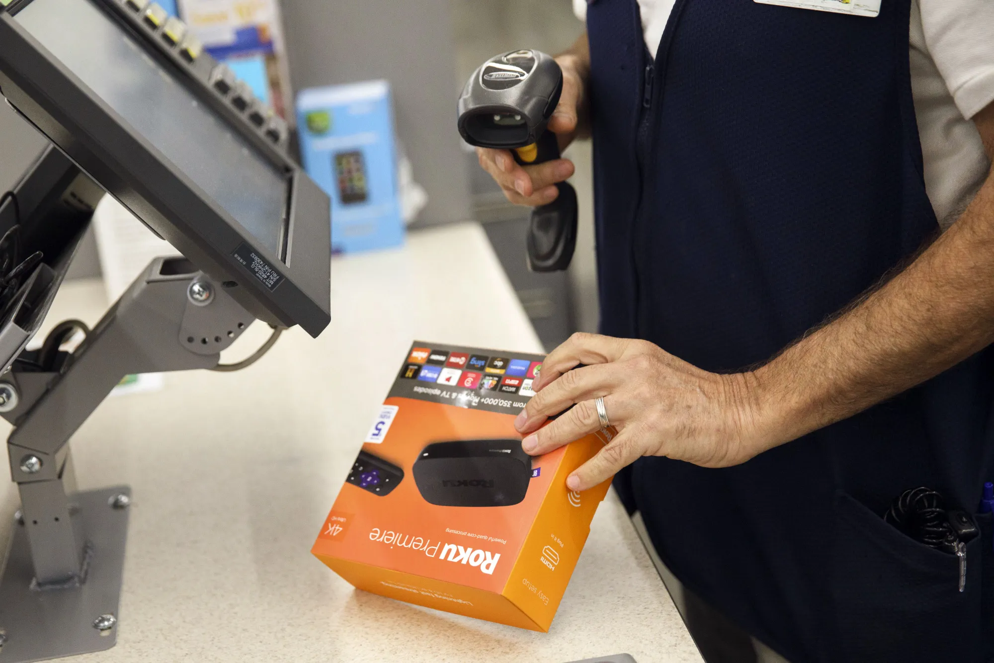 An cashier scans a Roku Inc. Premiere device.

