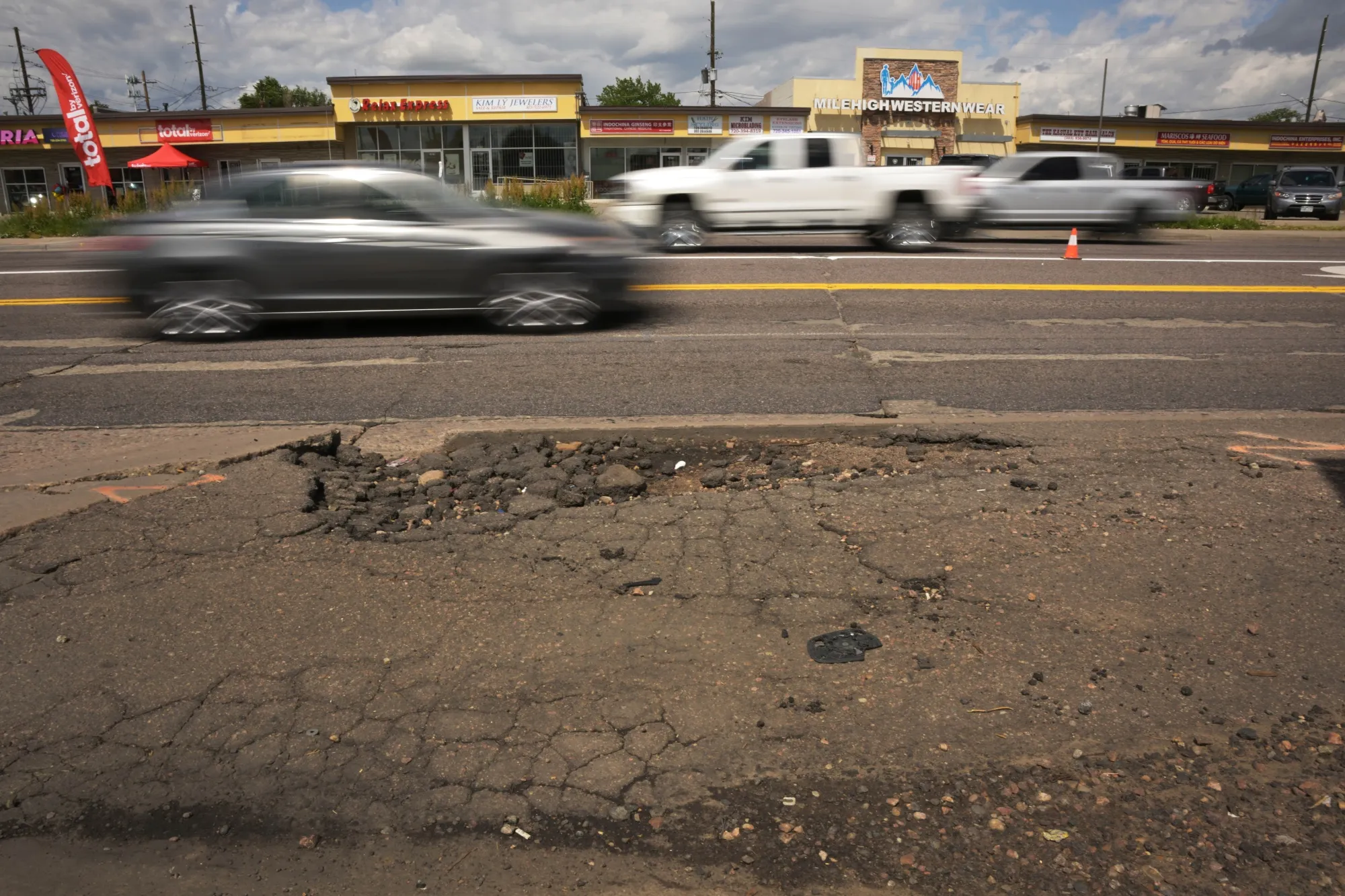 Heavily damaged sidewalks line a roadway&nbsp;in Denver’s&nbsp;Little Saigon business district in 2024. A new sidewalk fee for all property owners is set to reform the city’s&nbsp;