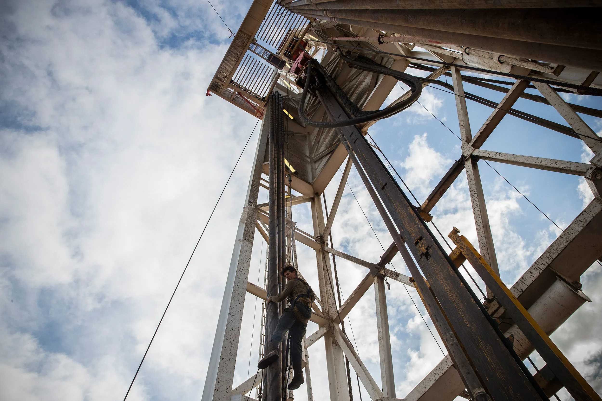 A derrick hand is lowered down in the Bakken shale formation on July 23, 2013 outside Watford City, North Dakota.
