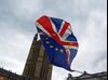 An anti-Brexit demonstrator waves a combined British Union flag, also known as a Union Jack, and European Union (EU) flag outside the Houses of Parliament in London, U.K., on Tuesday, Jan. 29, 2019. The pound is vulnerable to swings Tuesday as traders tweak positions ahead of votes by lawmakers to change Theresa May's Brexit deal.