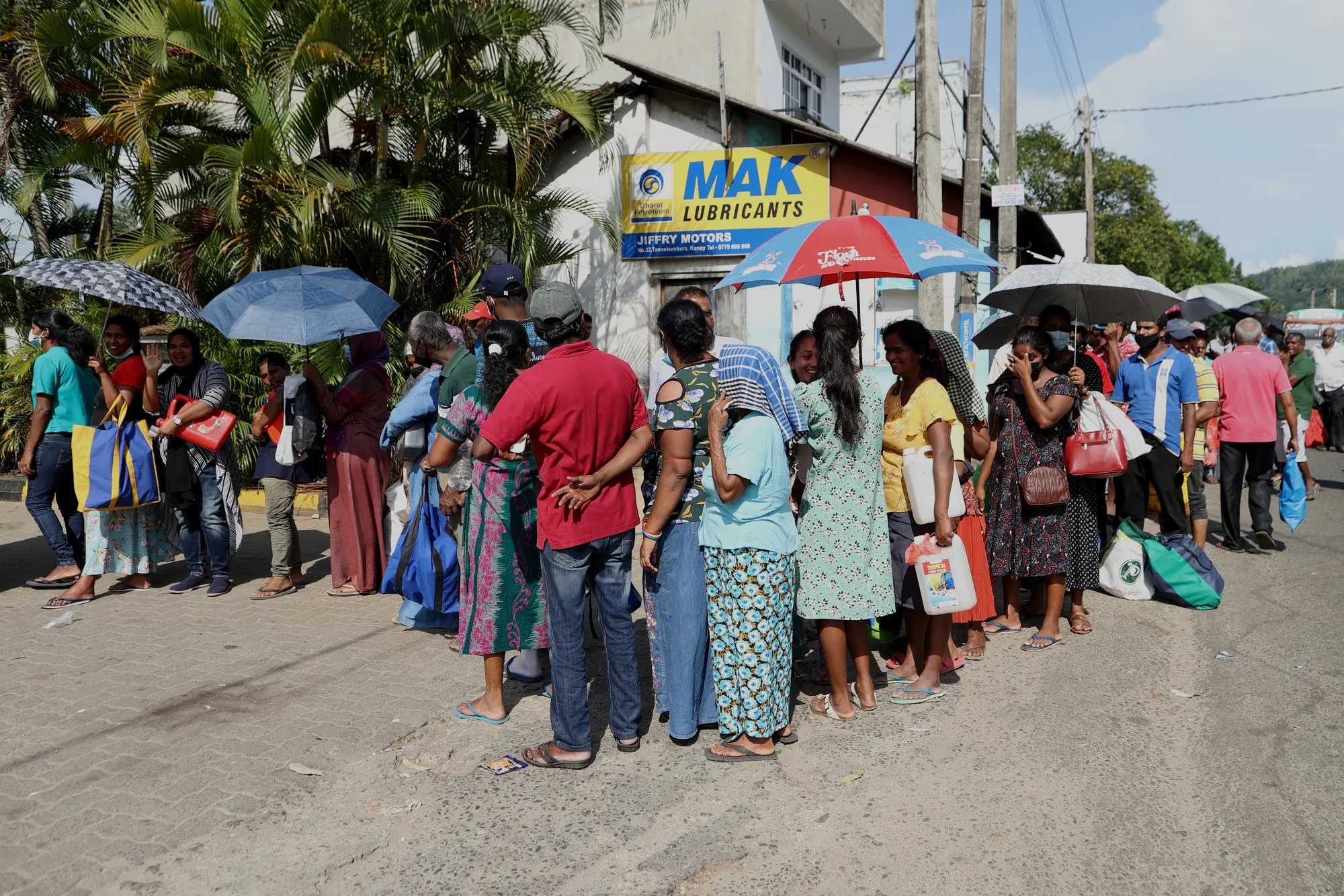 People wait in line to buy kerosene at a gas station in Kandy, Sri Lanka, on&nbsp;June 13.&nbsp;