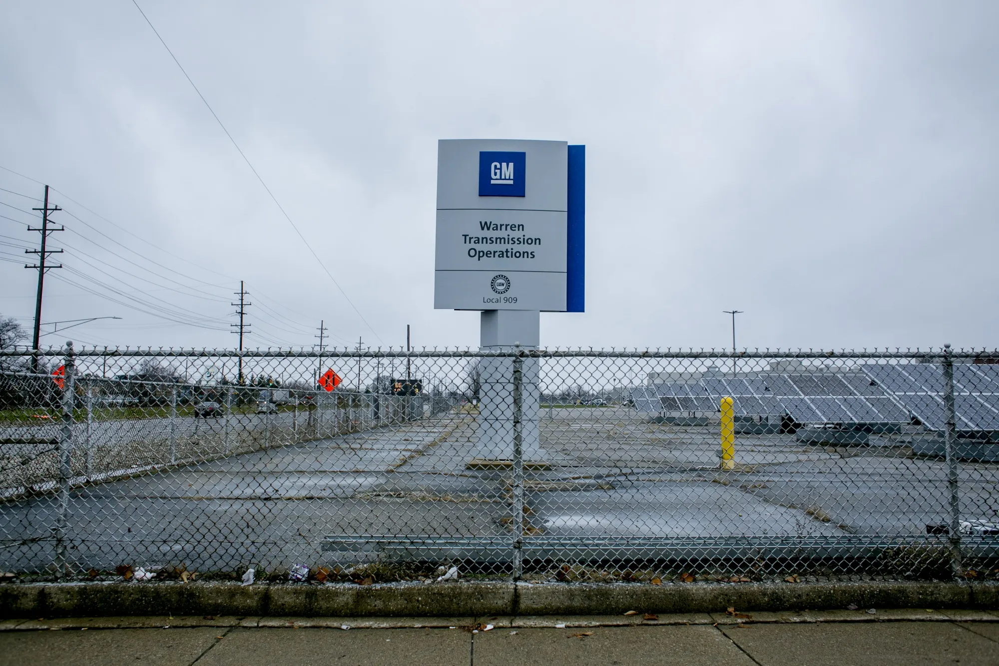 Signage stands on display outside the General Motors Co. transmission operation plant in Warren, Michigan.