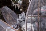 A fisherman builds traps in the Baga fish market in Maiduguri, Nigeria.