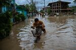 Residents wade through flood waters in Kawit on Oct. 30.