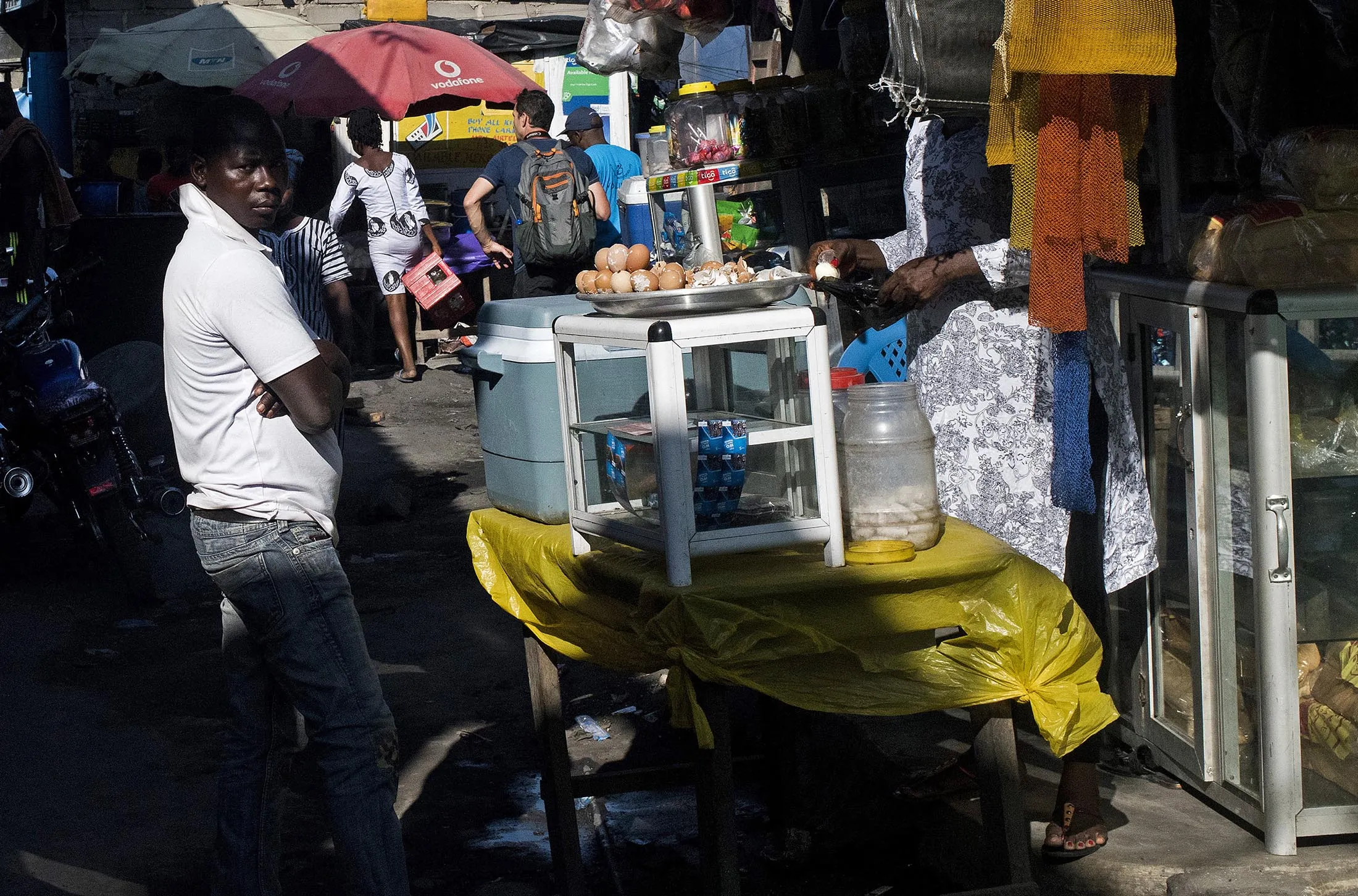 Customers walk through a market in Accra, Ghana.
