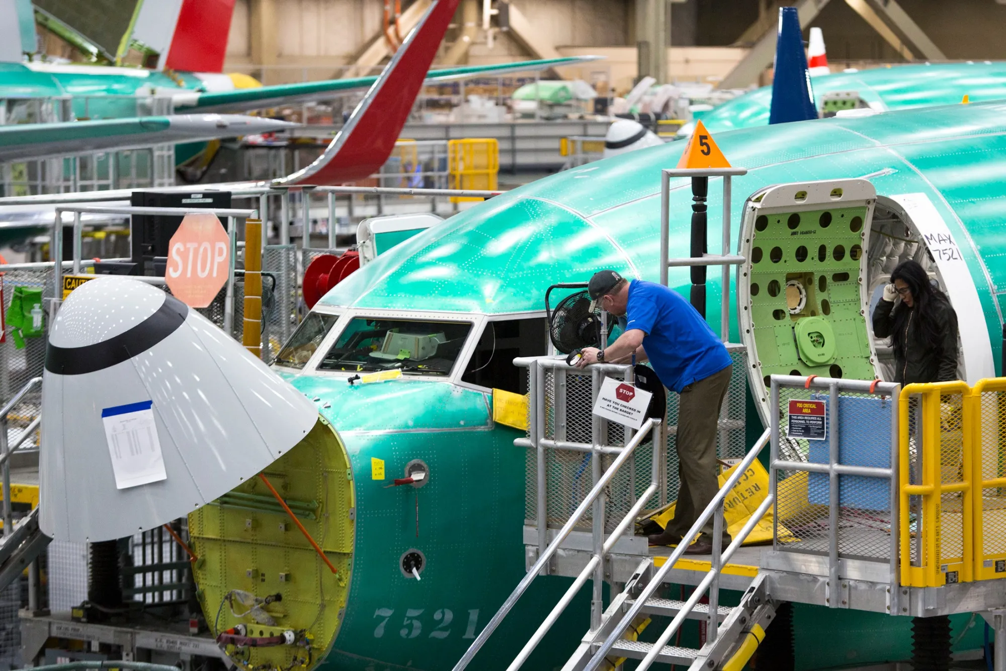 Employees work on Boeing 737 passenger jets at the company’s factory in Renton, Washington, US.