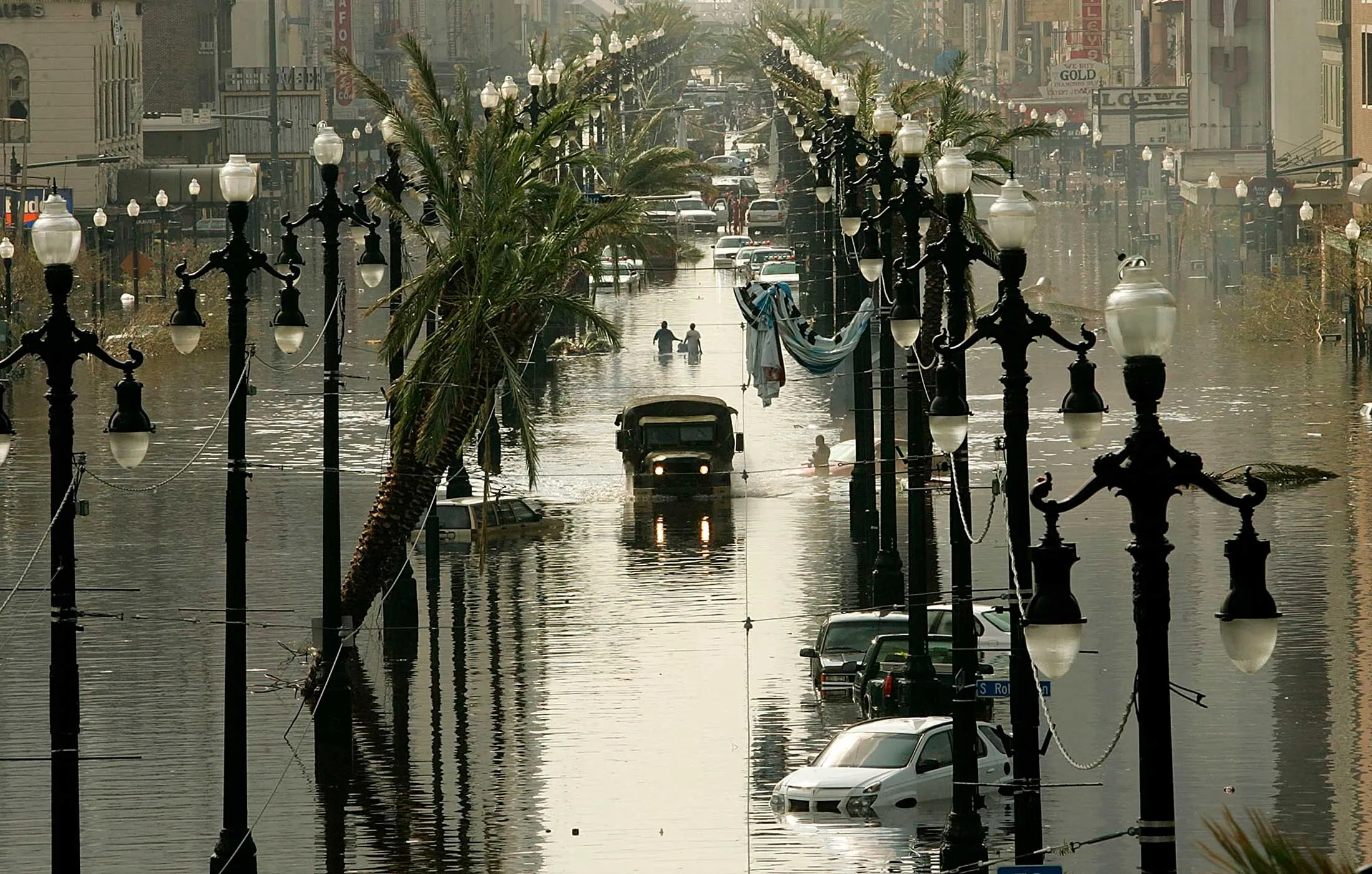 A military truck drives down a flooded Canal Street following Hurricane Katrina’s landfall in New Orleans on Aug. 31, 2005.
