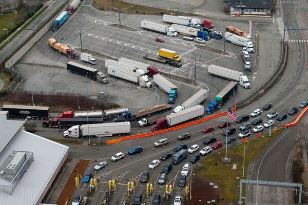 A Canada-US Border Crossing As Trump To Impose Tariffs On March 4