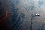 A boat collects spilled oil from the Deepwater Horizon well in the Gulf of Mexico on April 28, 2010