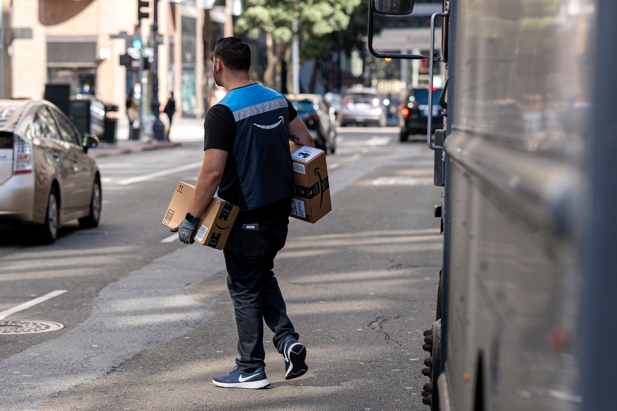 A worker delivers Amazon packages in San Francisco.