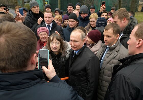 In His Hometown, Putin Gets Surprise Grilling...And Gives Gifts