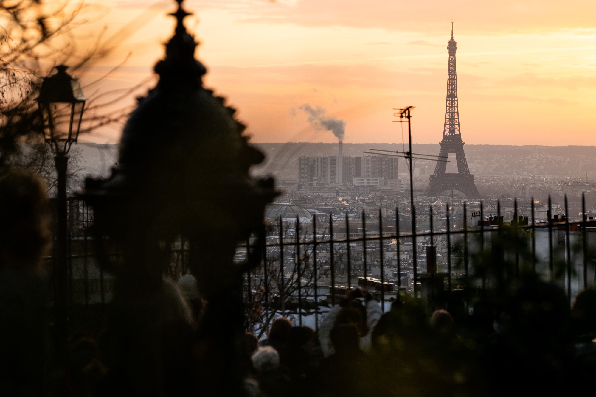 The Eiffel Tower and city rooftops during cold weather in central Paris. Photographer: Benjamin Girette/Bloomberg