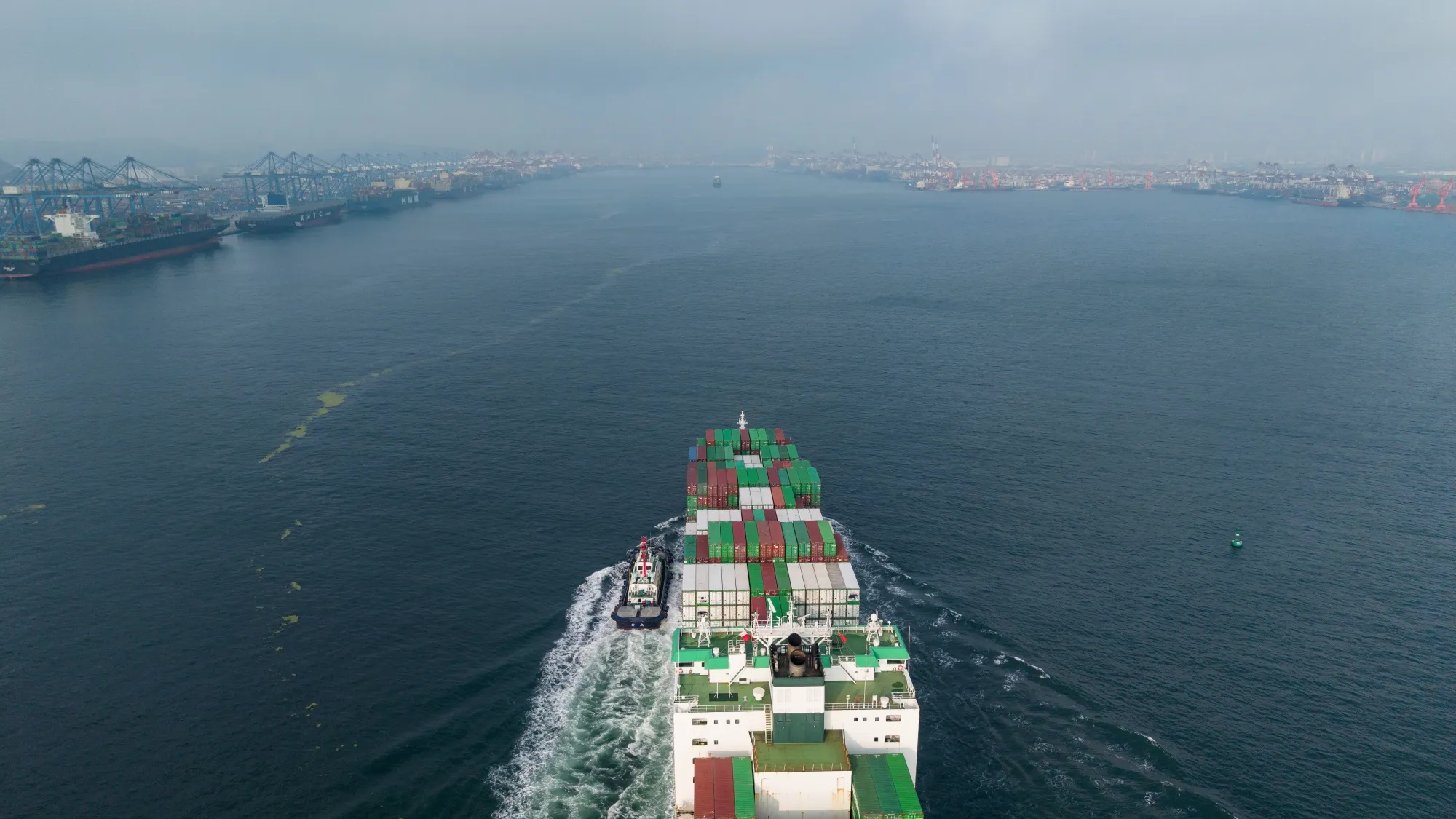 A cargo vessel sails past Qingdao Port in &nbsp;China.