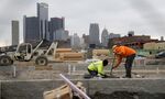 A construction crew works on a new housing development along the riverfront in Detroit.