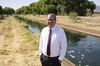 Paul Gardner, Queen Creek’s utility services director, stands by a canal containing treated wastewater.