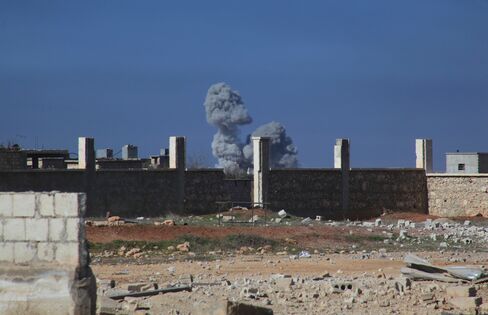 Smoke rises following air strikes on the village of Marasat al-Khan in Syria