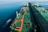 A support vessel sails alongside the crude oil tanker 'Devon' as it sails through the Persian Gulf towards Kharq Island oil terminal to transport crude oil to export markets in Bandar Abbas, Iran, on Friday, March 23, 2018. Geopolitical risk is creeping back into the crude oil market.