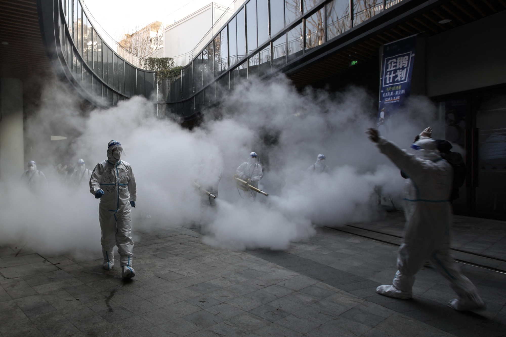 Health workers spray disinfectant outside a shopping mall in Xi'an on Jan. 12.