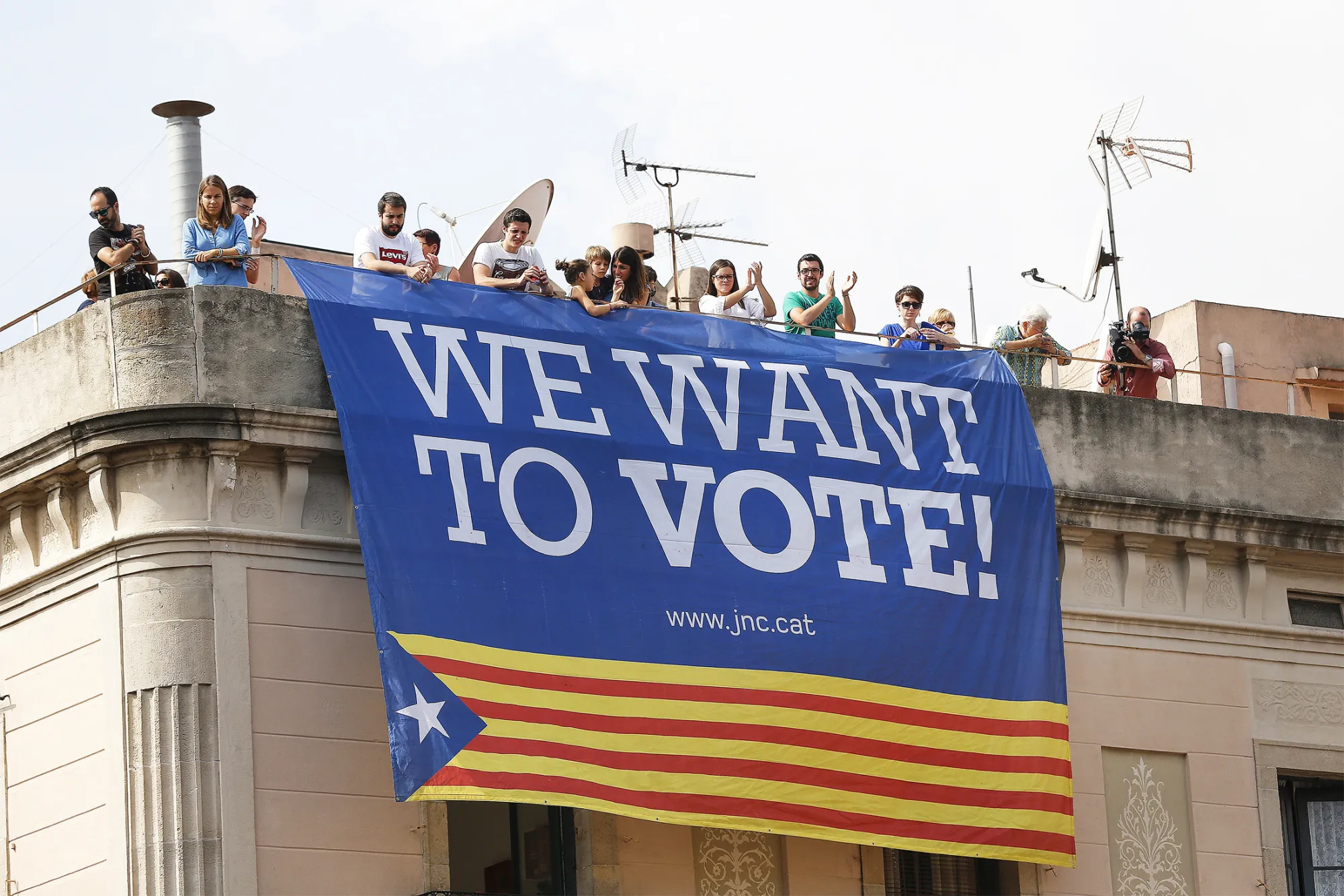 A giant pro Catalan independence banner hangs from a roof balcony during the La Merce festival in Barcelona on Sept. 23,