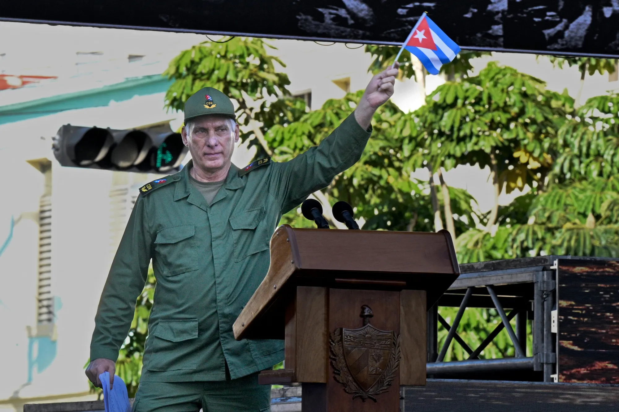President Miguel Díaz-Canel waves a Cuban flag in Havana on April 16.