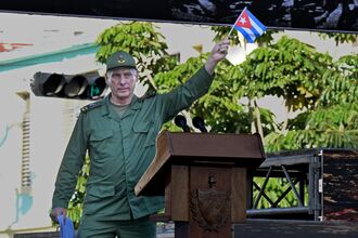 President Miguel Díaz-Canel waves a Cuban flag in Havana on April 16.