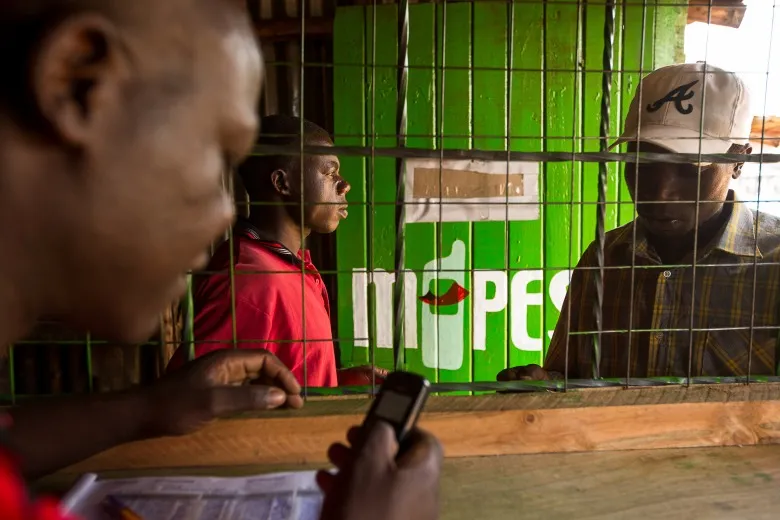 Residents use the M-Pesa banking service at a store in Nairobi.