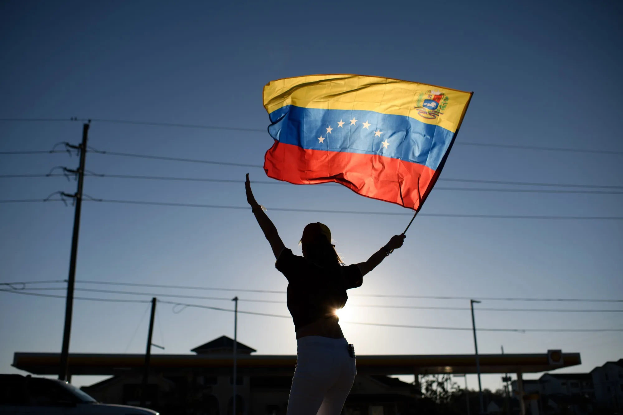 A demonstrator holds a Venezuelan flag during a rally in Katy, Texas, US, on Saturday.