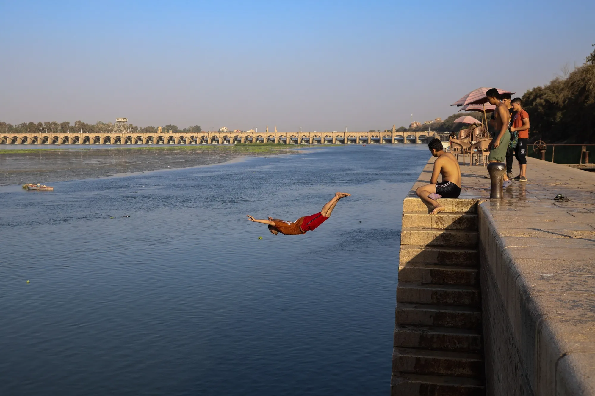 Youths cool off on the banks of the River Nile during high temperatures at the al-Qanater al-Khayreya on the outskirts of Cairo, Egypt, on Friday, June 7, 2024.