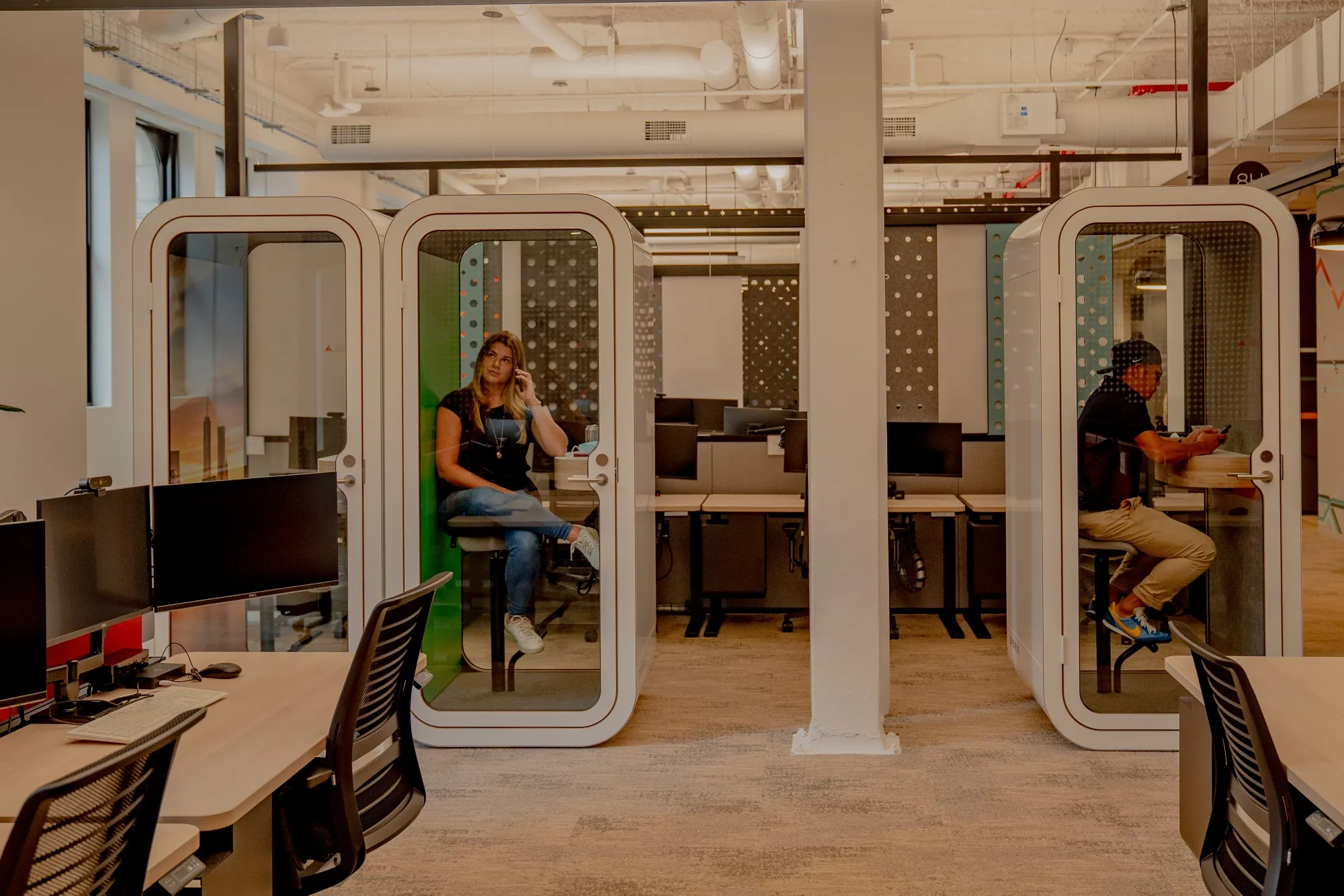 Phone booth style spaces offer privacy for workers at the new Mastercard office in New York.