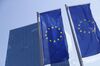 The stars of the European Union (EU) sit on banners flying outside the European Central Bank (ECB) headquarters following a rates decision news conference with ECB President Mario Draghi in Frankfurt, Germany, on Thursday, July 25, 2019. The ECB sent its strongest signal yet that monetary support for the euro-area economy will be stepped up after the summer break, with lower interest rates and renewed asset purchases on the table.
