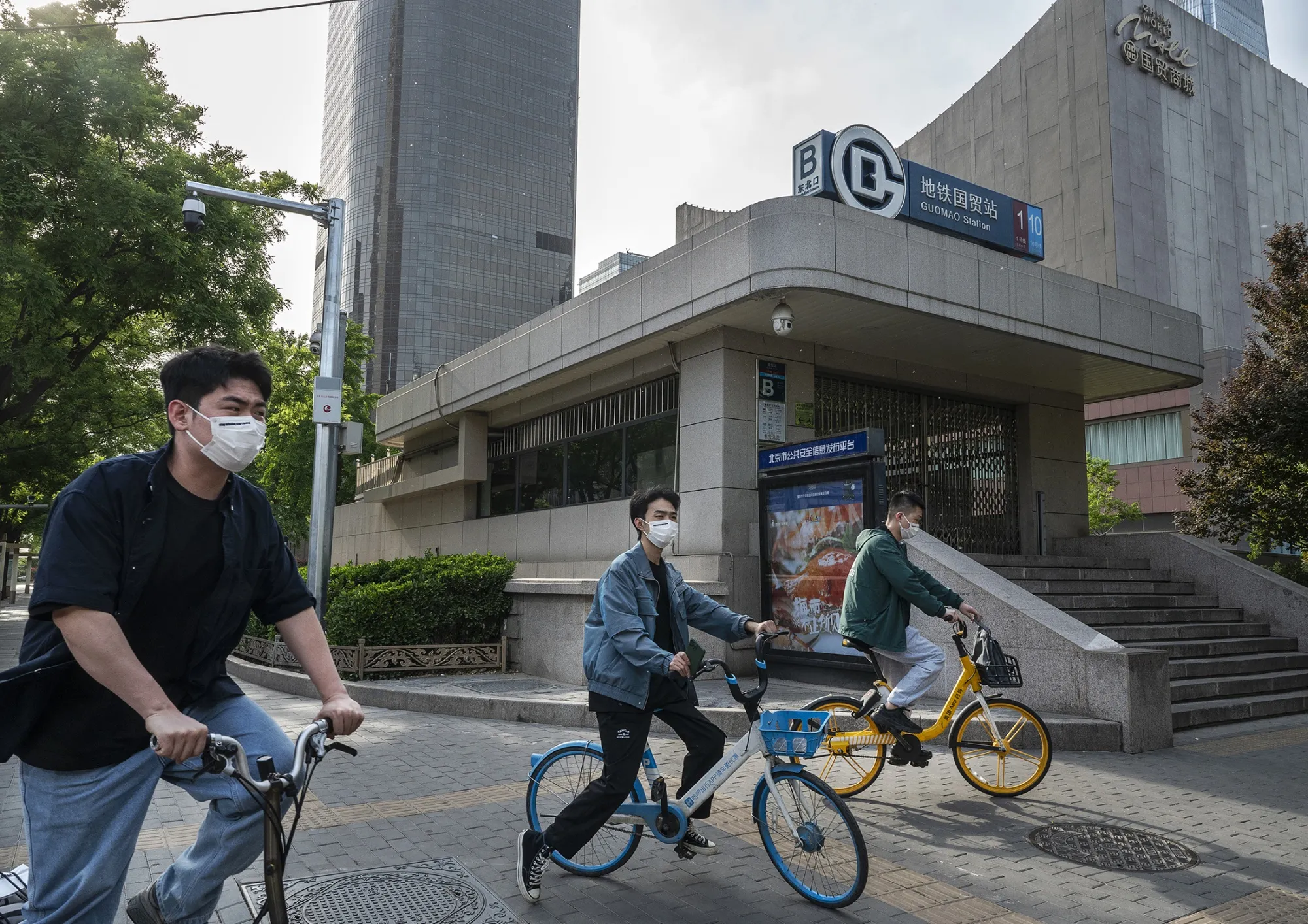 Cylists on shared bikes in front of a locked gate of a subway station in Beijing, on May 4.