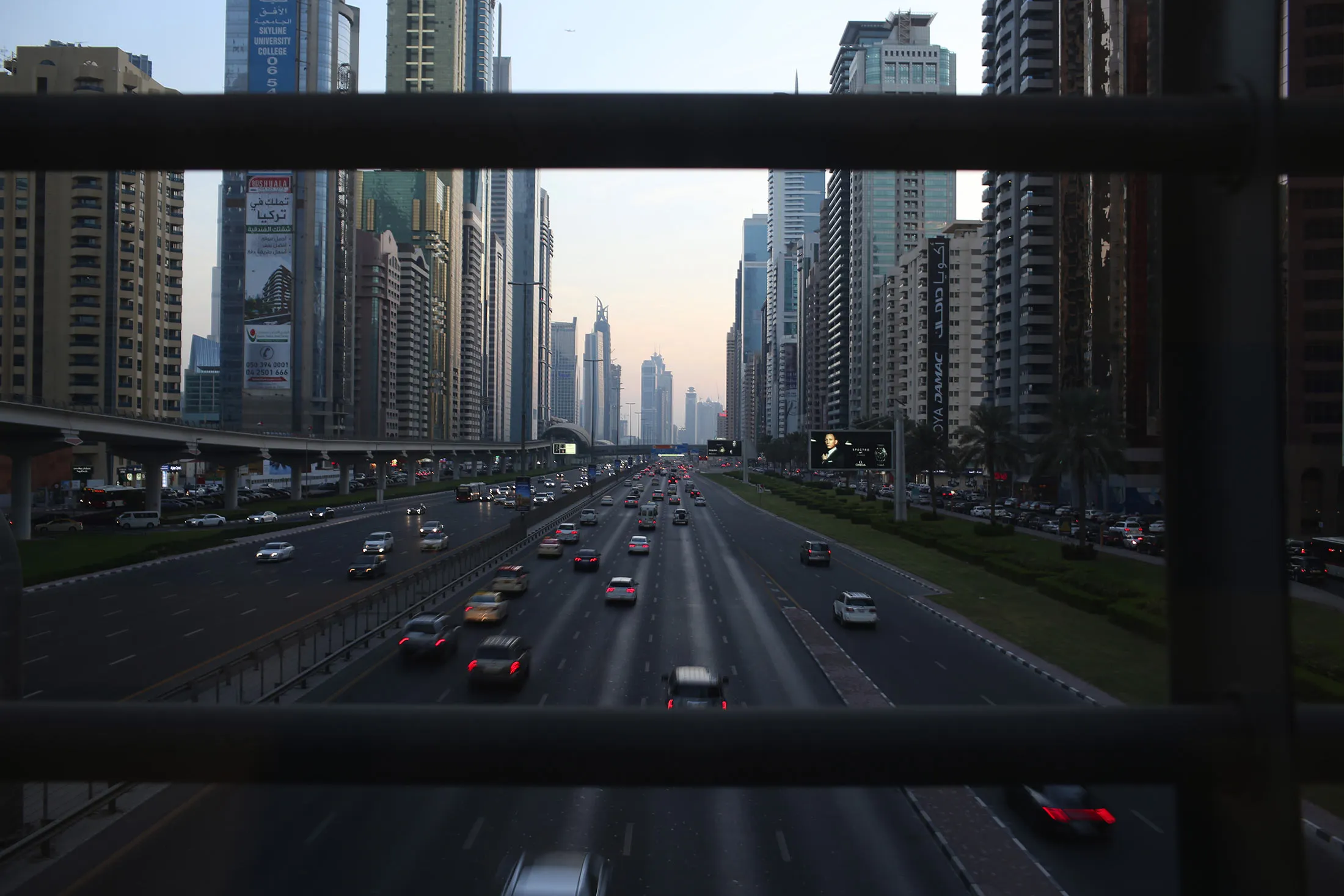 Evening traffic passes along the Sheikh Zayed highway past city skyscrapers in Dubai, United Arab Emirates,
