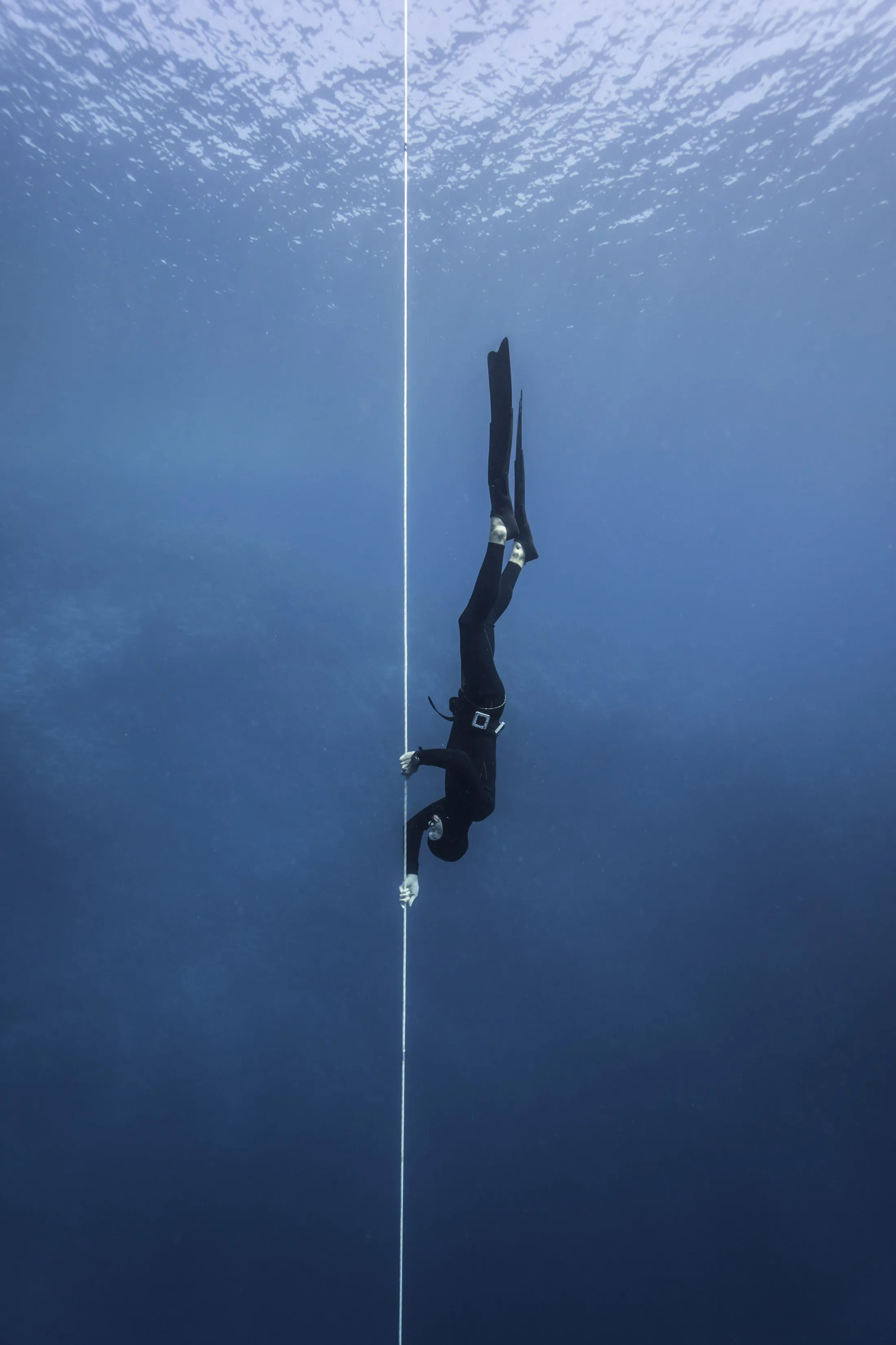 The author climbs down a rope during a freediving course off the coast of Dahab, Egypt.
