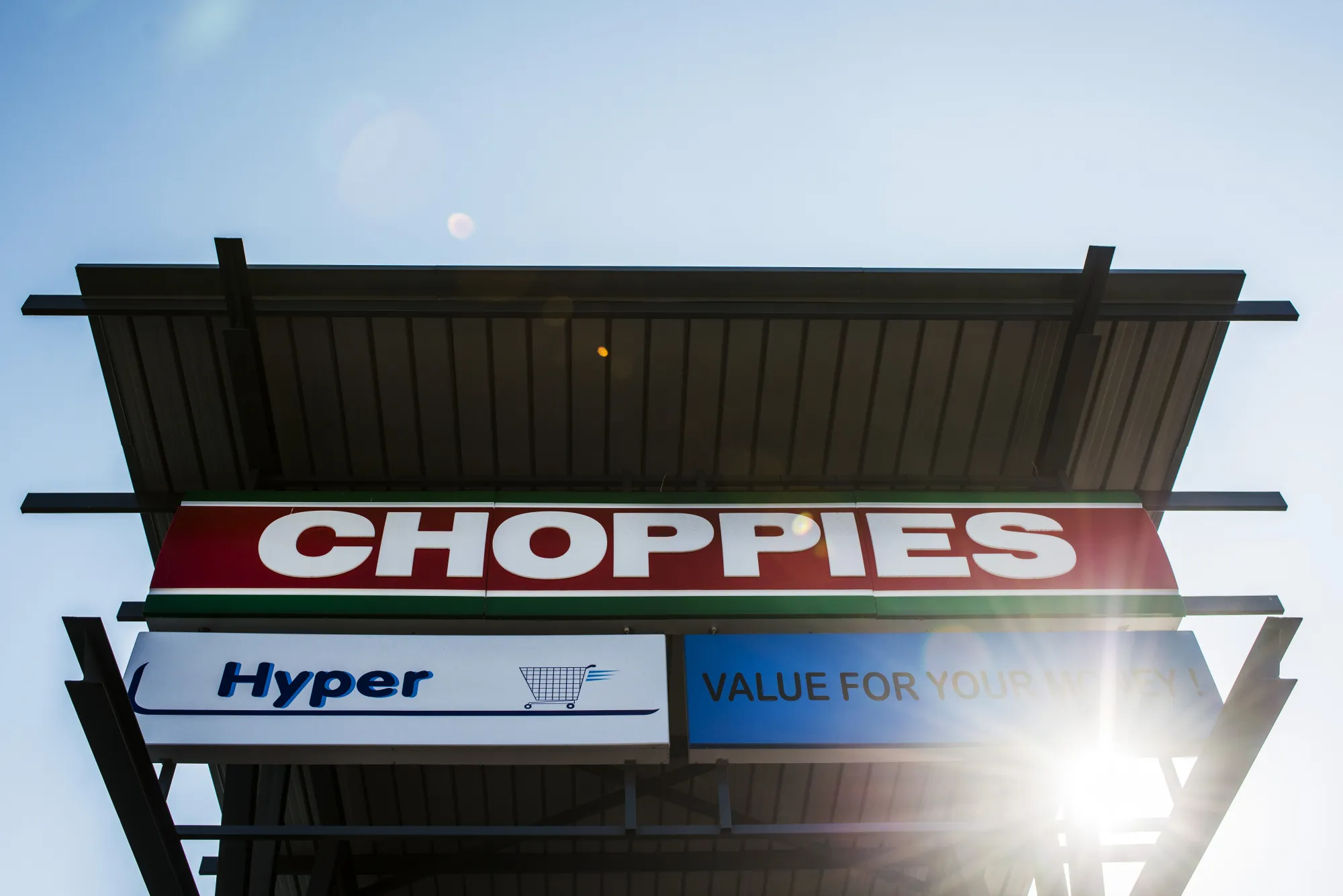 A sign sits above the entrance to a Choppies supermarket in Rustenburg.