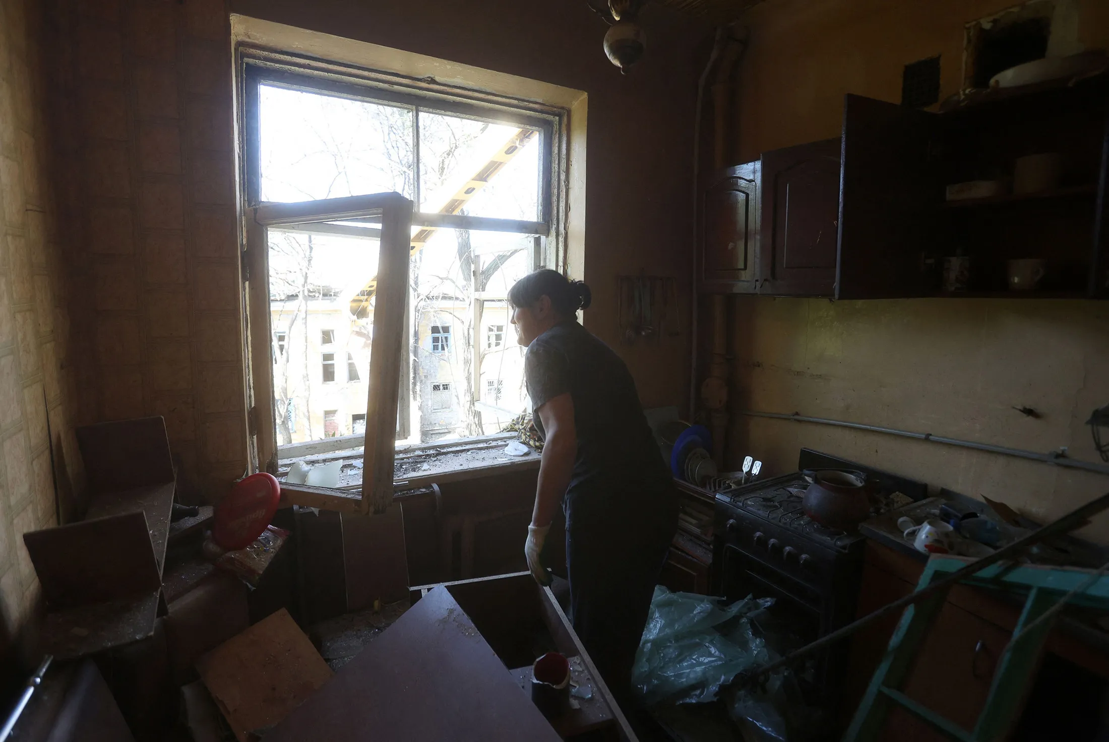 A woman cleans her house from debris after a missile strike in&nbsp;Donetsk region, on Sept. 29.