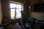 A woman cleans her house from debris after a missile strike in Donetsk region, on Sept. 29.