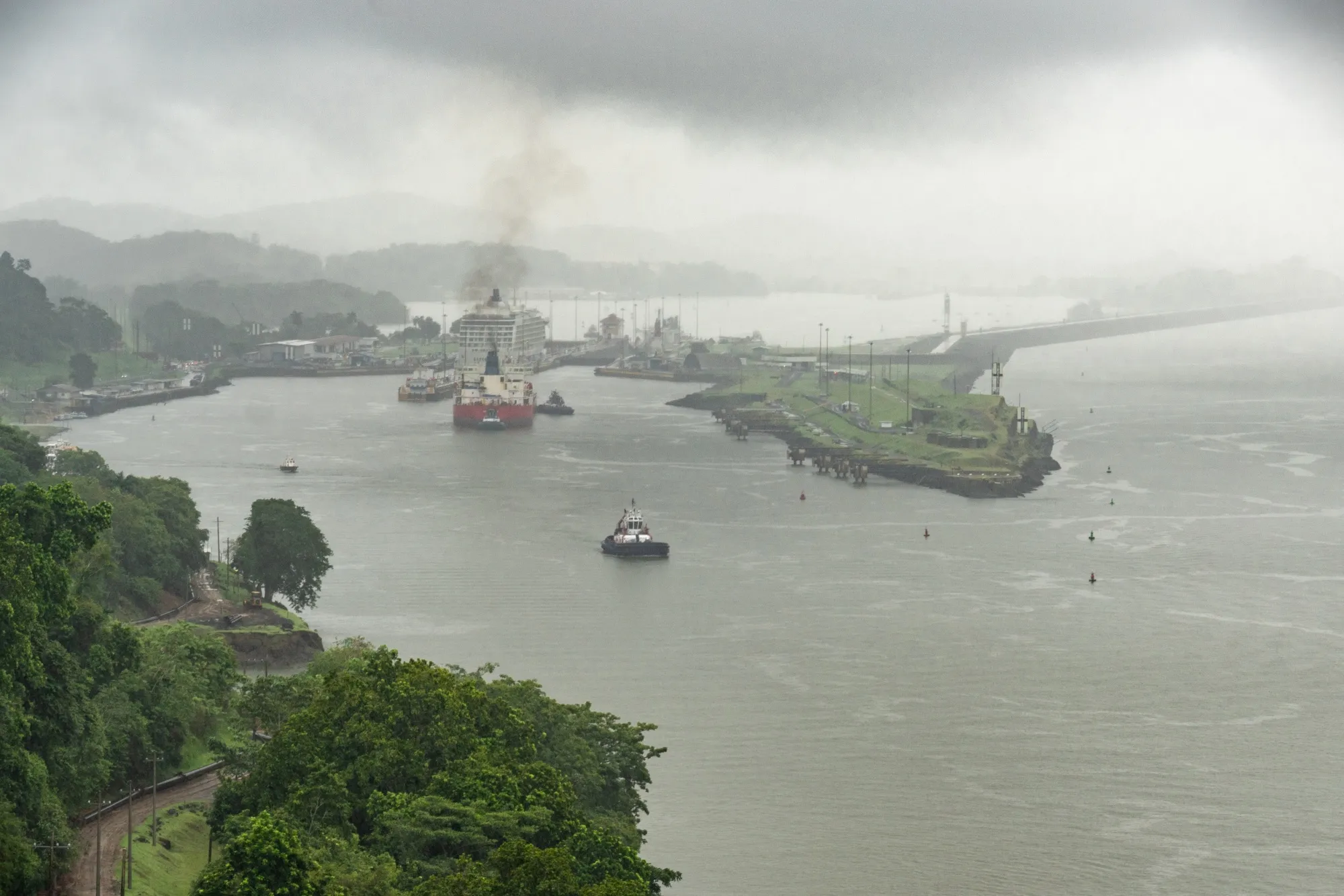 A tugboat navigates a shipping vessel into the Pedro Miguel Locks near Paraiso, Panama.