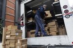 A U.S. Postal Service worker prepares packages for delivery during Cyber Monday in New York, on Nov. 29.