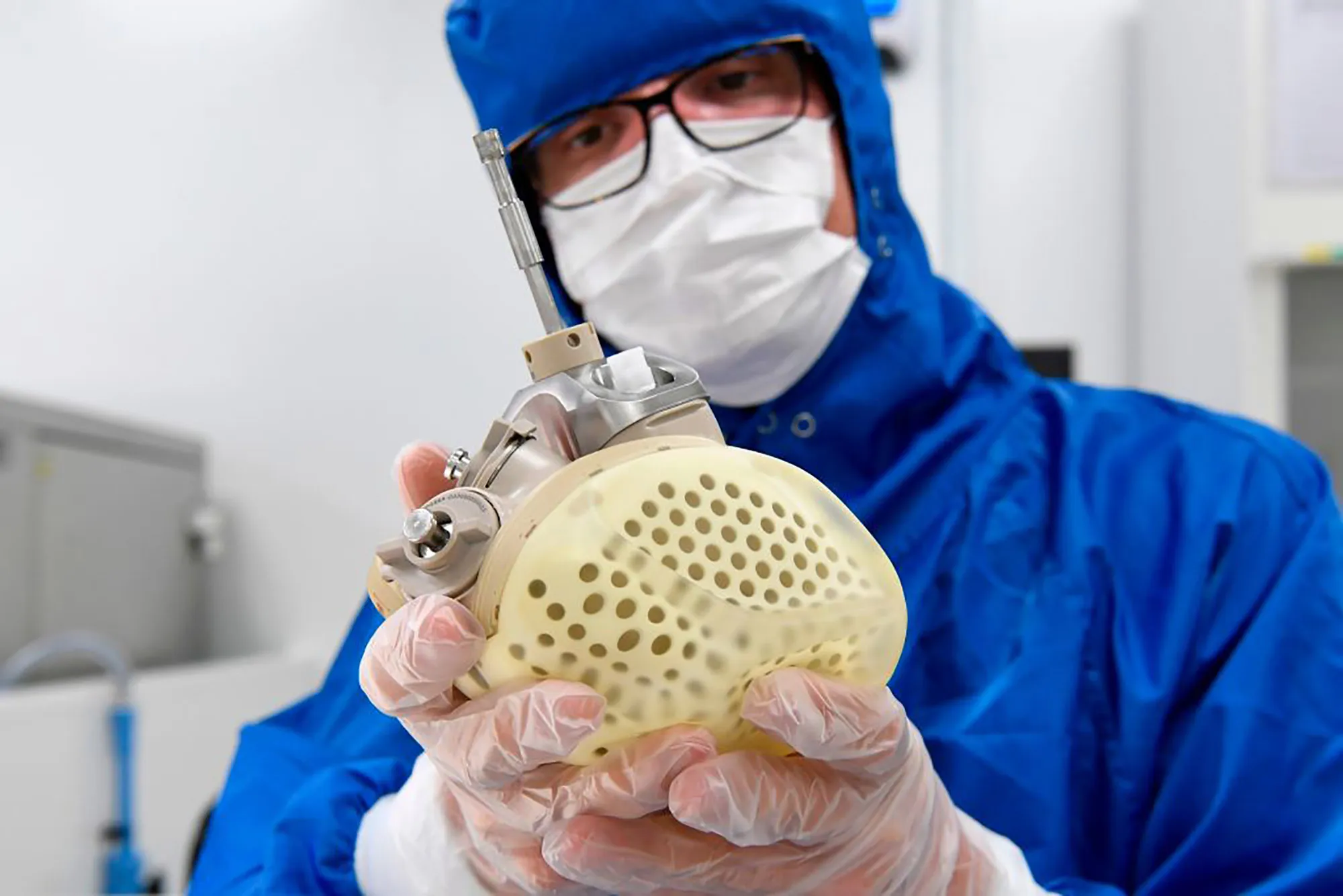 A Carmat employee shows an auto-regulating, bioprosthetic artificial heart.