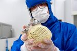 A Carmat employee shows an auto-regulating, bioprosthetic artificial heart.