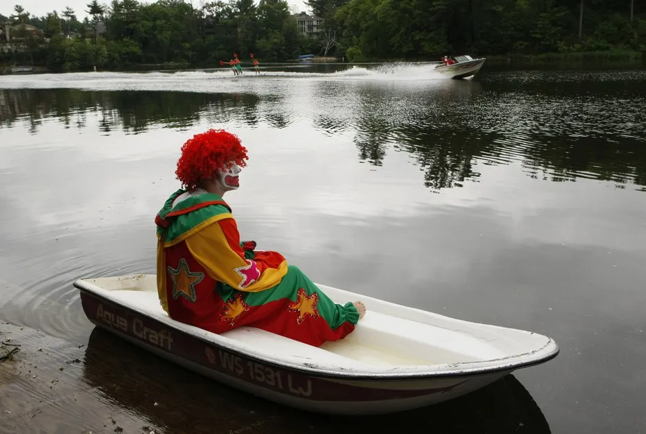 Aqua the Clown waits for his cue to perform during the Tommy Bartlett Show in Wisconsin Dells on Lake Delton, Wisconsin. The self-proclaimed "waterpark capital of the world" is uneasily awaiting the start of the summer tourist season this year.